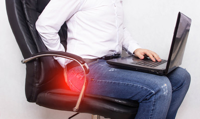 A man in a white shirt holds on to the anus the concept of pain in the rectum, hemorrhoids,...