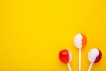 Sweet lollipops on yellow background. sweet candy concept
