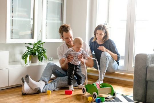 Young parents playing with baby
