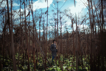 Beautiful girl in the tall grass in autumn.