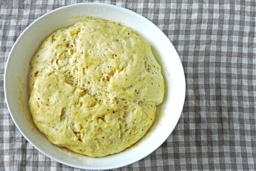 Raw yeast dough in a bowl. Soft and airy yeast dough.
