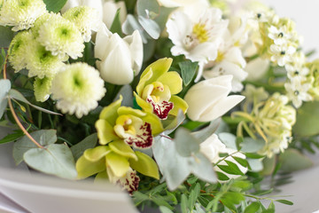 image of a girl in apron holding a flower in her hands with a manicure on a white background