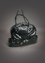 Black leather bag on gradient gray background