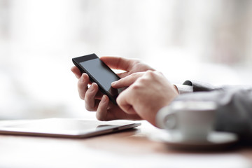 close up.the businessman uses a smartphone. photo with copy space