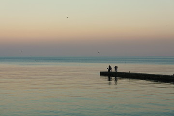 Fototapeta na wymiar silhouette of fisherman at sunset