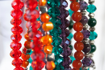Hanging beautiful colorful bead necklaces in store.