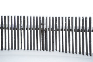 wooden old gray fence in the snow