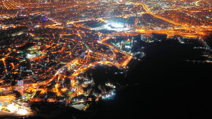 Aerial drone night shot of famous small safe port of Mikrolimano with sailboats docked, Piraeus, Attica, Greece