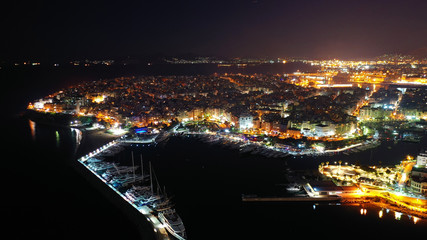 Aerial drone night shot of famous small safe port of Mikrolimano with sailboats docked, Piraeus, Attica, Greece