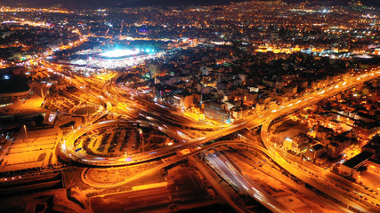 Fototapeta na wymiar Aerial drone night shot of illuminated ring highway junction near the sea