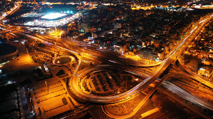 Aerial drone night shot of multilevel junction highway with moderate traffic