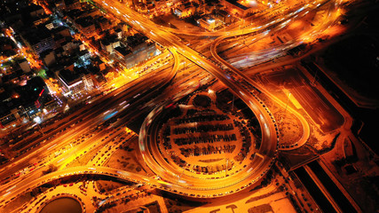Aerial drone night shot of multilevel junction highway with moderate traffic