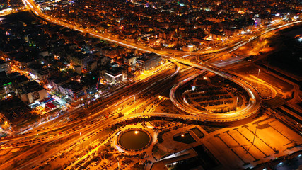 Fototapeta na wymiar Aerial drone night shot of multilevel junction highway with moderate traffic