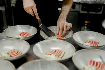 the cook arranges the meat in the dish
