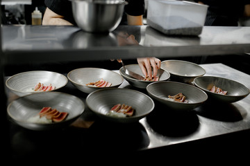 the cook arranges the meat in the dish
