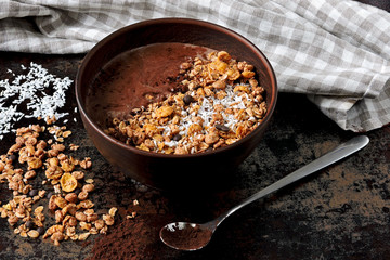 Delicious breakfast bowl with chocolate yogurt and granola. Eco food. Healthy breakfast. Super food. Flat lay.