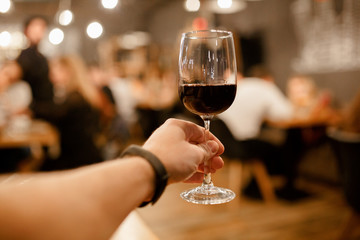 the man raises his glass of wine, toast with alcohol