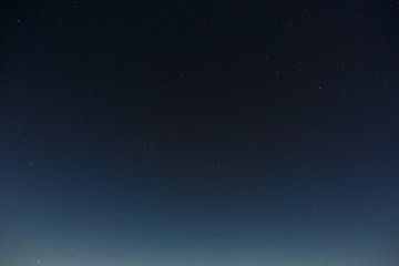 Fototapeta premium Stars in the night sky. Outer space background with the full moon photographed.
