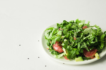 healthy vegan green salad in white bowl