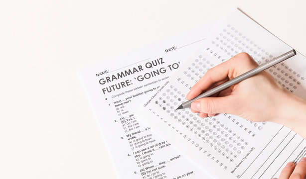 Test Of English Multiple Choice On Table.Woman Takes An Entrance Exam