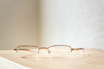 reading glasses on a wooden table