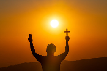 The human hand holds cross a christian religion faith concept