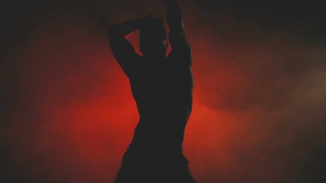 Silhouette of a dancing sexy man