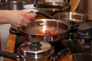 cook preparing lamb soup with vegetables in the kitchen