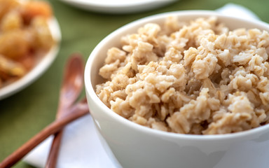 Oatmeal in a white bowl. Healthy breakfast.
