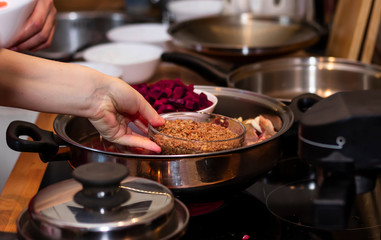 cook preparing lamb soup with vegetables in the kitchen