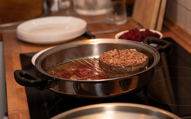 cook preparing lamb soup with vegetables in the kitchen