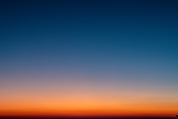 Sky gradient from blue to orange sunset - Powered by Adobe