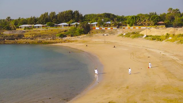 brahma kumaris in white saree on crescent beach in daman diu