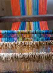 Colored threads of an ancient wooden loom