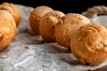 Cottage cheese balls on wooden skewers, lie on craft paper.