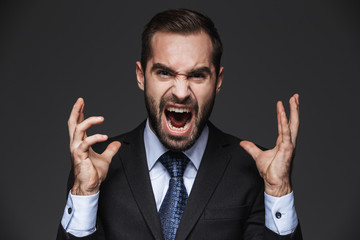 Portrait of a mad handsome businessman wearing suit