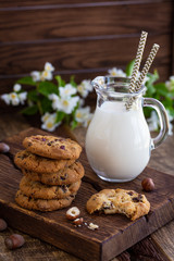 Chocolate chip cookies with milk on  wooden table
