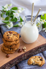 Chocolate chip cookies with milk on  wooden table