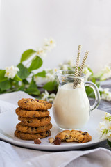 Chocolate chip cookies with milk on  wooden table