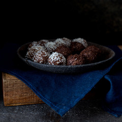 Chocolates on the plate with blue towel dark photo