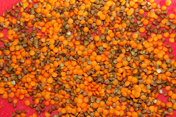 Colorful Food Ingredients Background.  Pile of Red Lentil And Brown Buckwheat Background. Top View. Red Lentil And Buckwheat Background, Texture.