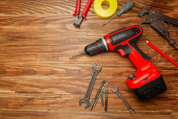 different construction tools on wooden background with copy space. diy construction tools on the...
