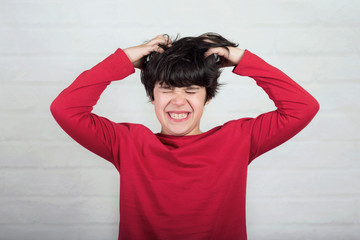 boy scratching his hair for head lice