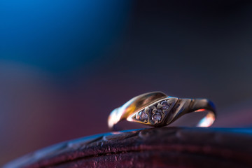 Gold ring with crystals on blue background