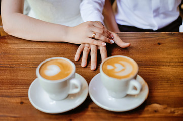 man and woman hands. love and cup coffee concept