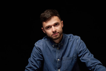Obraz premium Handsome man in denim shirt looking at camera