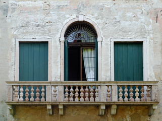 Fototapeta na wymiar Tree green ancient windows. Bassano del Grappa, Vicenza, Veneto, Italy. 9th August 2019