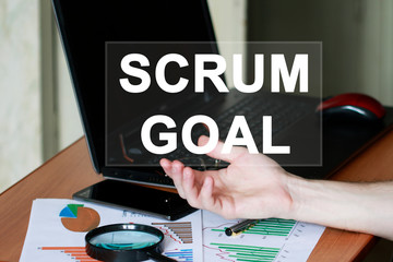 Businessman clicks button scrum goal word button on virtual panel.