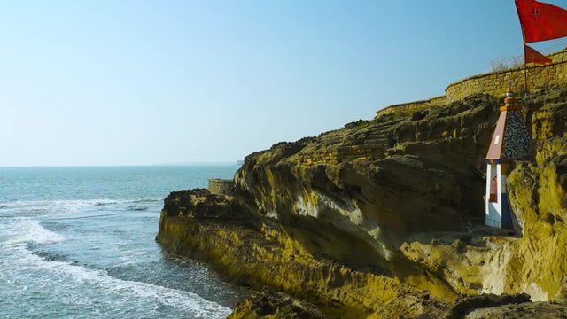 Panning shot from a hindu temple nestled in a cliff overlooking the arabian sea in Diu Gujarat india