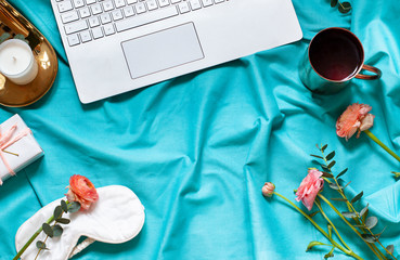 Lifestyle concept flat lay on the blue bed blanket with a keyboard. Valentines day, Womens day or Morthers day holiday frame. Top view. Copy space